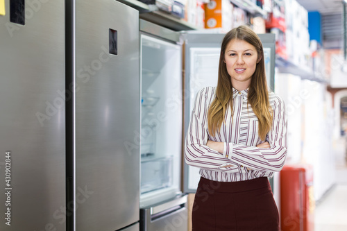 Portrait of young attractive woman in store of house appliances
