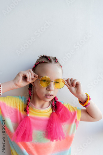 Konstfotografi Teenage girl straightens her yellow sunglasses