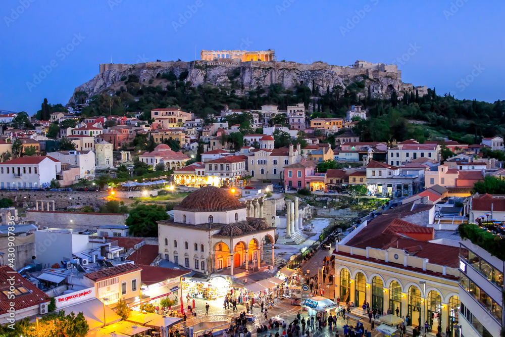 Cityscape of Athens, Greece at dusk with Parthenon lit up in the background