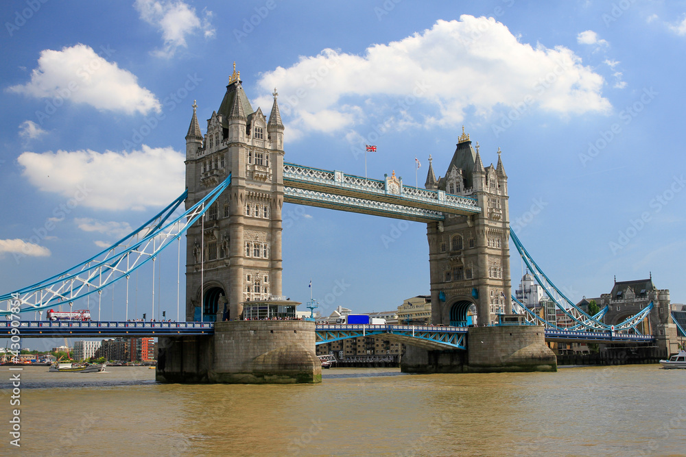 Tower Bridge over Thames with blue sky and clouds, London, England