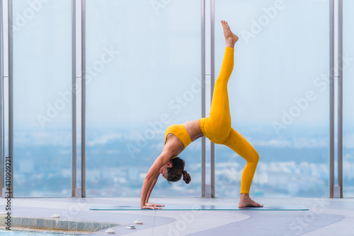 woman pratice yoga workout training pose show body flexibilty and balance photo