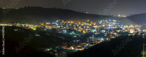 Night scene in the valley bright houses with colorful lights makes the night scene in the countryside more vibrant in the Da Lat plateau, Vietnam © huythoai