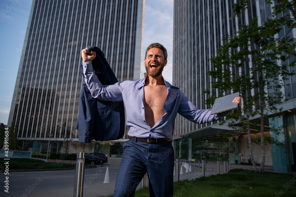 Fototapeta premium Excited businessman model in unbuttoned shirt outdoor office city. Ambitions concept and success business.