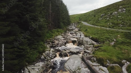 Panoramic view of glenmacress waterfall located in the wicklow mountains, Ireland. On a cloudy day. photo