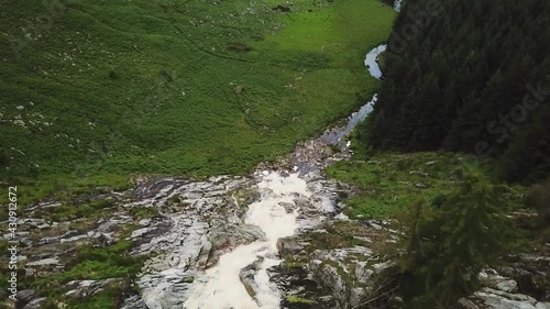 Panoramic view of glenmacress waterfall located in the wicklow mountains, Ireland. On a cloudy day. photo