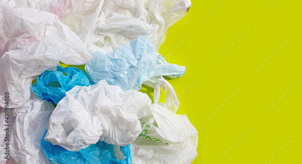 Fototapeta premium Crumpled plastic bags on green background.