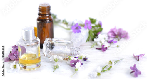 essential oil and freshness flowers in bottle on a table