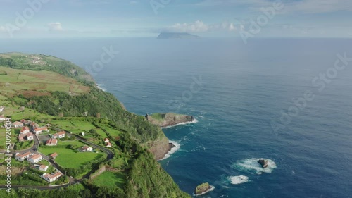 Wallpaper Mural Birds eye view of Casa do Gato Tomas on hills of green Flores Island, Azores, Portugal, Europe. Aerial view of small village with ocean view on mountains, 4k footage with copy space  Torontodigital.ca