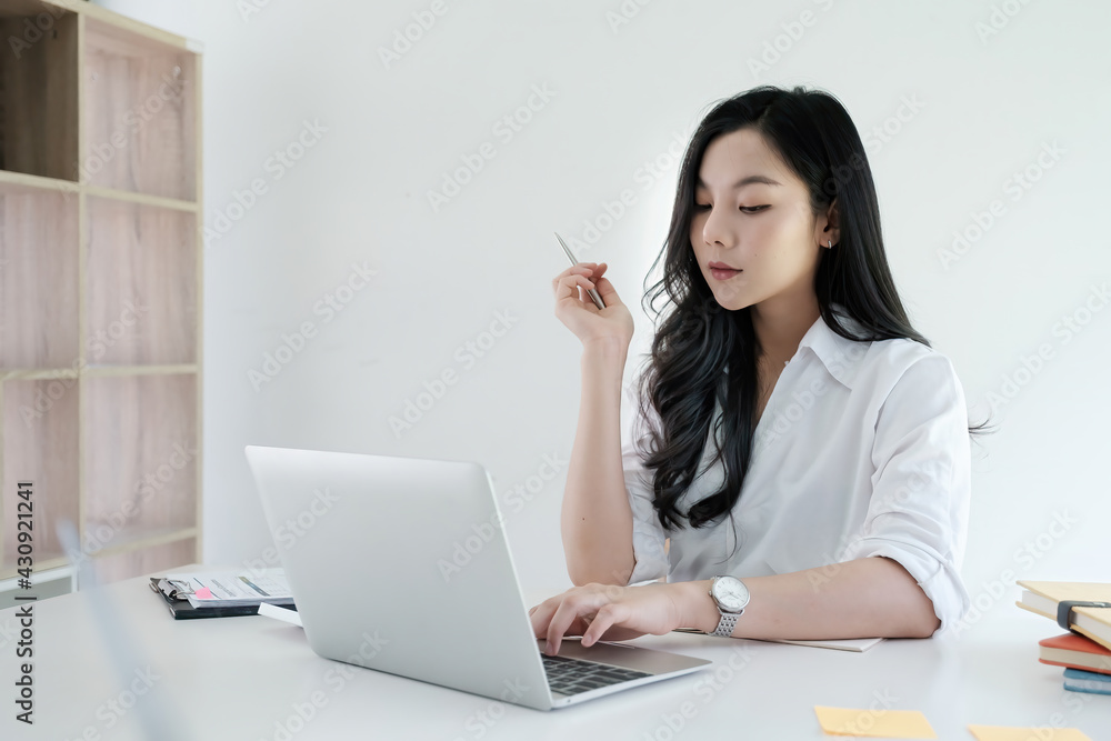 Business accounting using calculator applicatopn on laptop on wooden desk in office. Tax, Accounting, Statistics and Analytic research concept. Business accounting using calculator applicatopn on laptop on wooden desk in office. Tax, Accounting, Statistics and Analytic research concept.