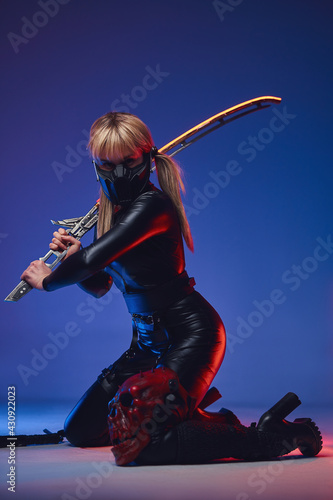 Futuristic woman in tight clothes with sword