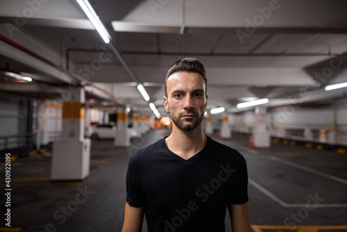 Portrait of handsome man at night at parking lot