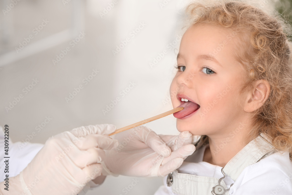 Pediatrician examining little girl in clinic Pediatrician examining little girl in clinic