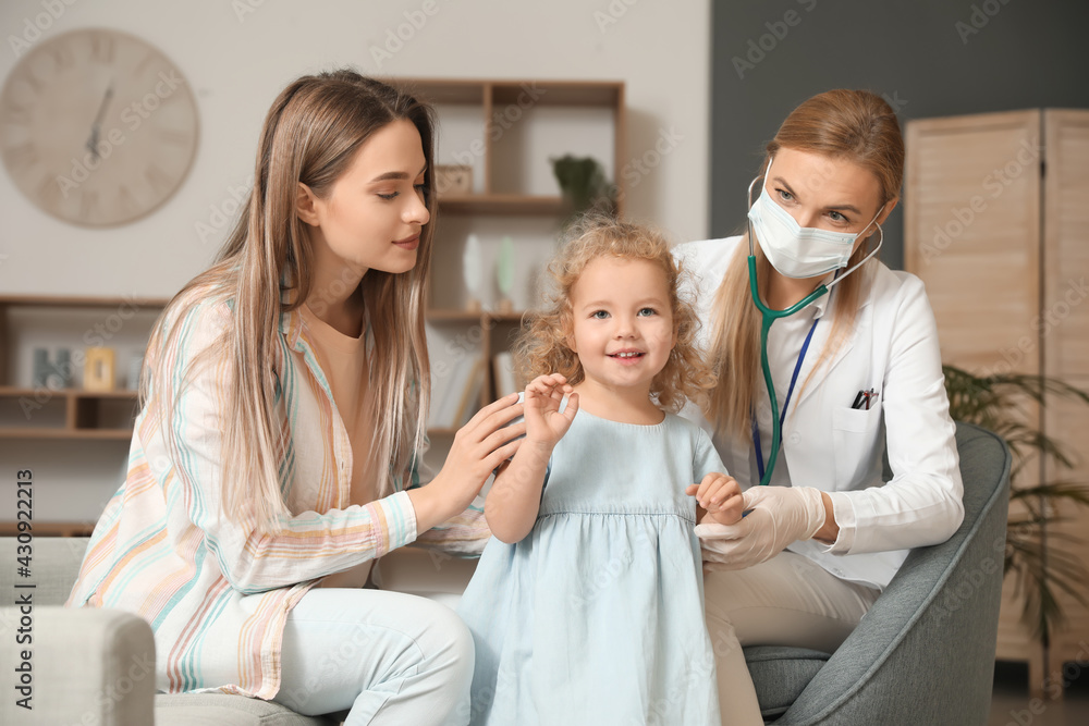 Pediatrician examining little girl at home Pediatrician examining little girl at home