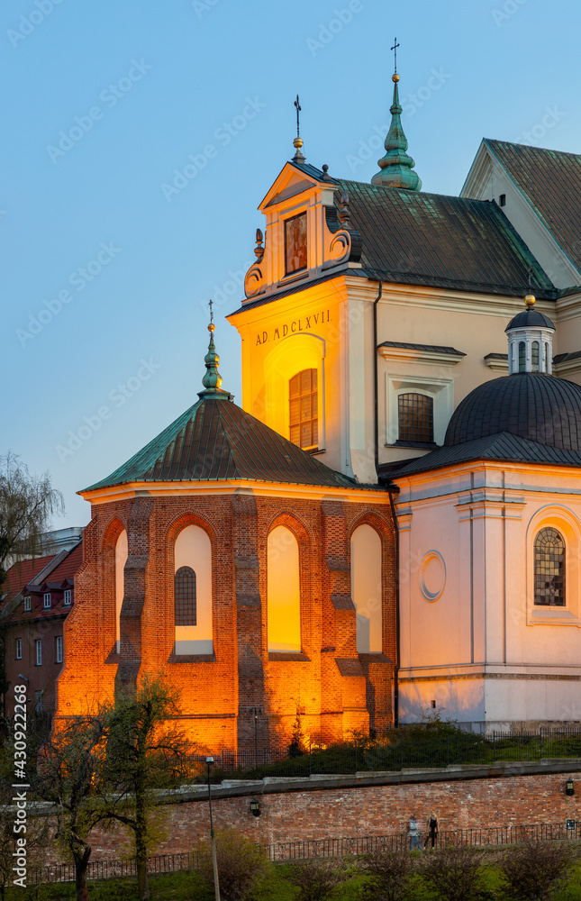 Evening view of St. Anna academic church, kosciol Sw. Anny, at Krakowskie Przedmiescie street in Starowka Old Town historic disrict of Warsaw, Poland