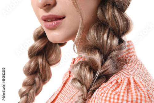 Beautiful young woman with braided hair on white background, closeup