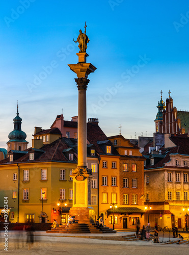Evening panorama of Castle Square with Sigismund III Waza column and colorful tenement houses in Starowka Old Town historic district of Warsaw, Poland