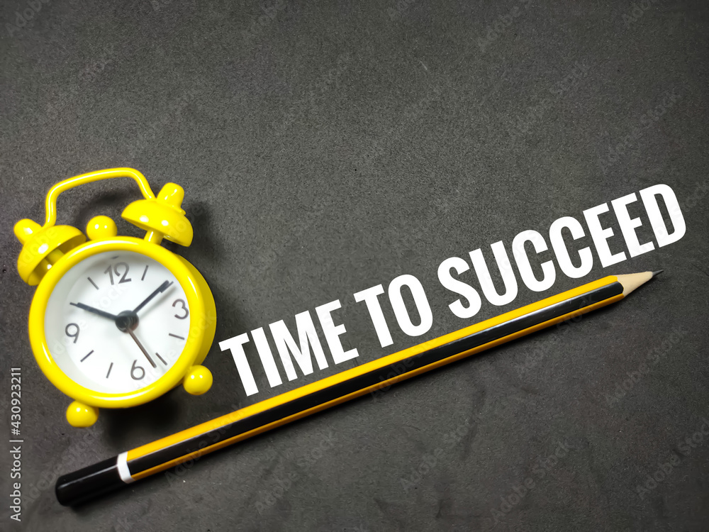 Business concept.Word TIME TO SUCCEED with clock and pencil on black background. Business concept.Word TIME TO SUCCEED with clock and pencil on black background.