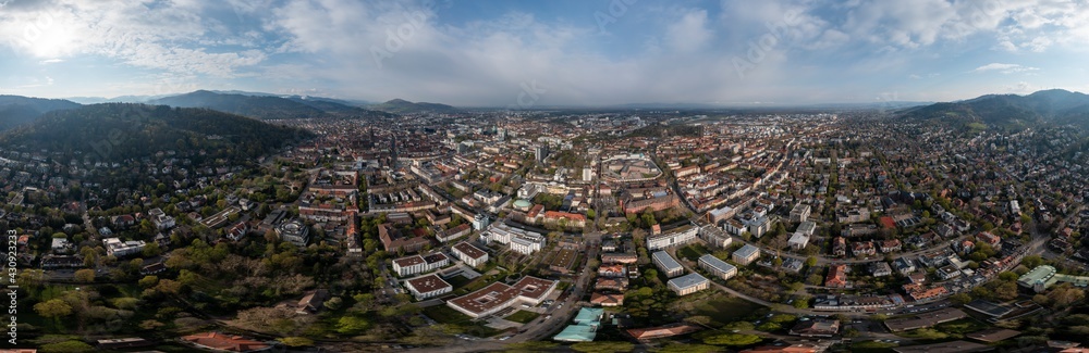 360 Grad Panorama Luftaufnahme von Freiburg im Breisgau im Sonnenaufgang mit dem Gefängnis in der Mitte und den umgebenden Bergen, Baden Wuertenberg, Deutschland