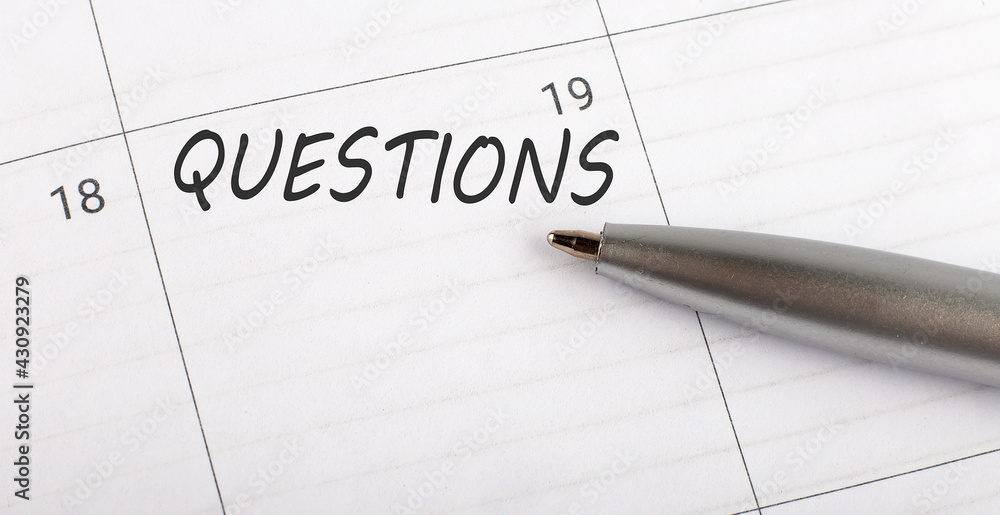 Text QUESTIONS written on calendar planner to remind you an important appointment with a pen on isolated white background. Text QUESTIONS written on calendar planner to remind you an important appointment with a pen on isolated white background.