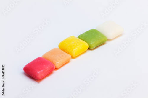 Fotografie chewy candy in the colors of the rainbow on a white background