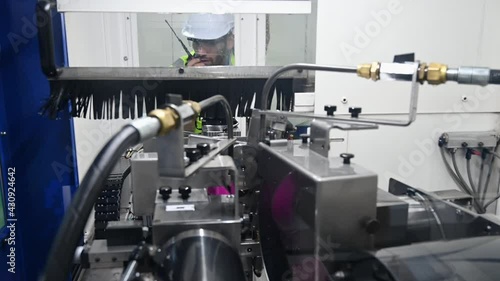 young maintenance Caucasian man in uniform checking on machine