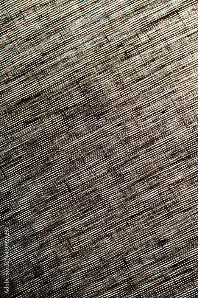 Fototapeta premium abstract rough colored linen natural fabric background, toning, short focus