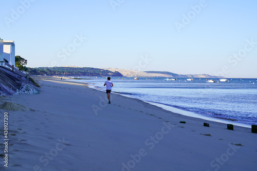 young man runner morning in Arcachon Bassin sand beach with dune du pyla view
