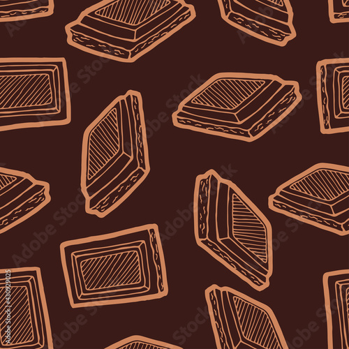 Seamless background with a pattern of hand drawn pieces of chocolate