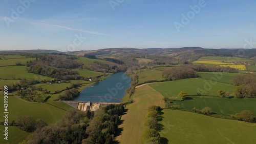 4K flying over hawkridge reservoir, drone moving forward over the green tree in front of the water dam wall, 60fps. photo