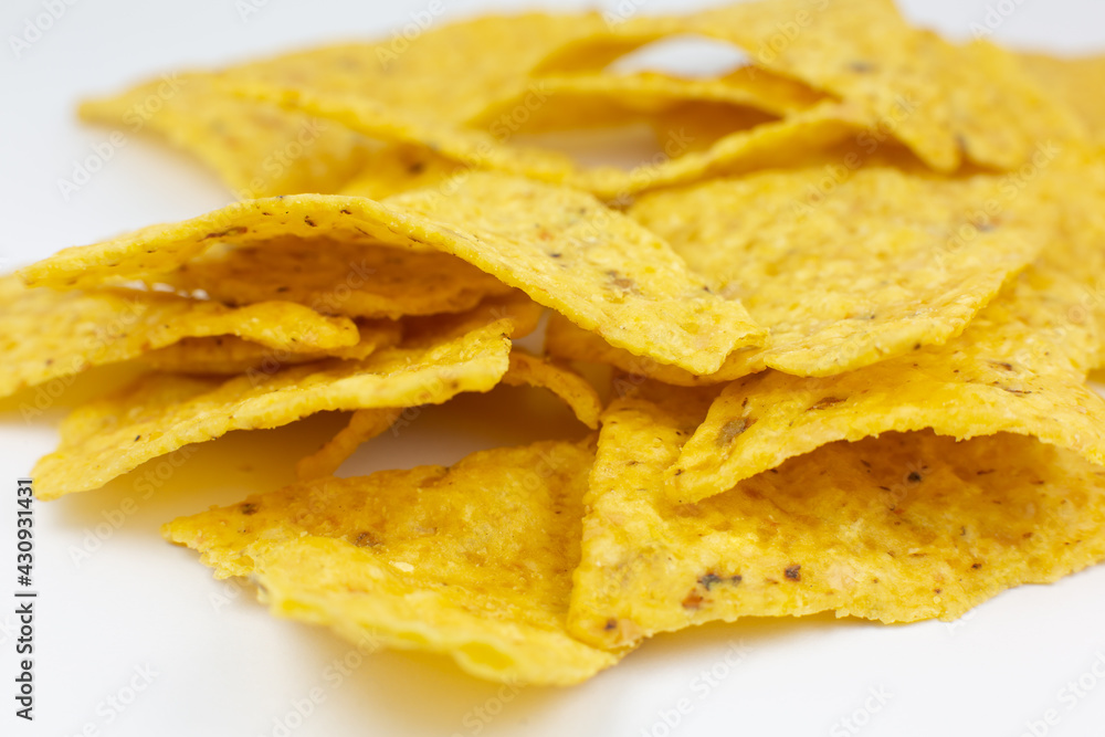 Close up, Triangular chips, mexican nachos, on white background. Perfect Tasty spicy snack for a beer. Close up, Triangular chips, mexican nachos, on white background. Perfect Tasty spicy snack for a beer.