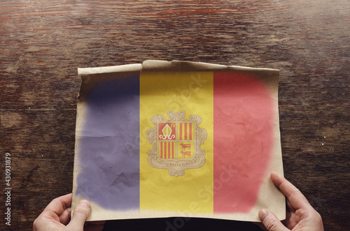 The red-yellow-blue Andoran National Flag on a tattered scrap of paper. photo
