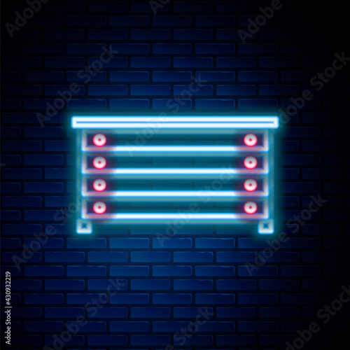 Glowing neon line Chest of drawers icon isolated on brick wall background. Colorful outline concept. Vector