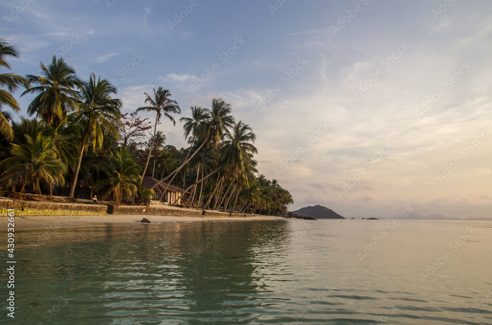 sunset on the sandy beach of a tropical island. sunset on the sandy beach of a tropical island.