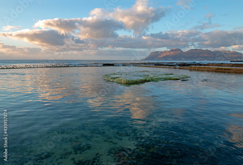 Dawn sunrise reflections over Dale Brook Tide Pool in Cape Town South Africa RSA
