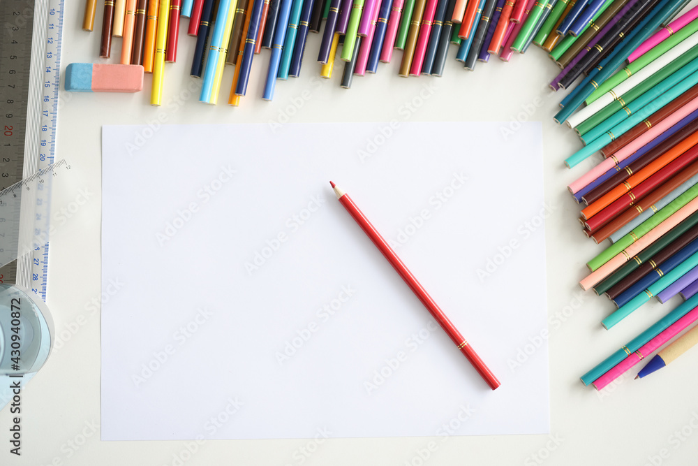 Red pencil lying on blank sheet of paper among multicolored Red pencil lying on blank sheet of paper among multicolored