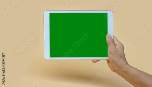 IPad handle the green screen with shadow below, light yellow background.