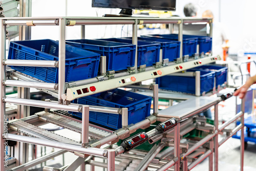 Obraz na plátně basket or plastic box container on roller rack or aluminum shelf with electronic display smart module system for management – control or operate stock such as quantity and data information etc