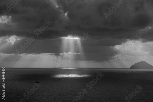 Landscape sunrise on Hon Chong cape, Nha Trang, Vietnam. Black and white. Morning sky, clouds, sun and sea water at dawn