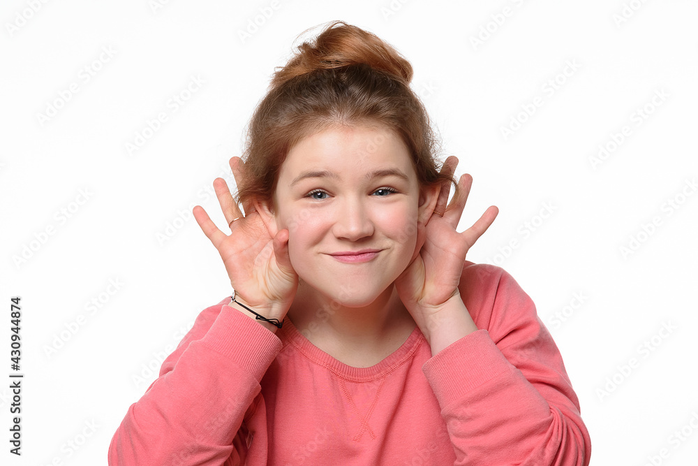 Close-up portrait of cheerful young girl making funny face. White background Close-up portrait of cheerful young girl making funny face. White background