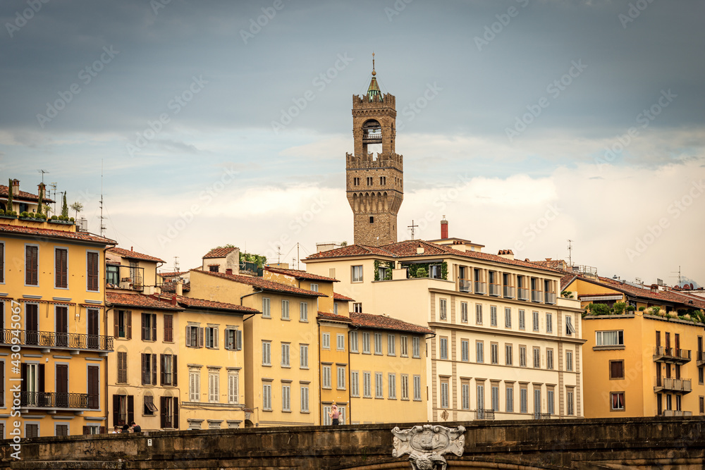 Florence cityscape with the Santa Trinita Bridge (XVI century) over the River Arno and the clock tower of Palazzo Vecchio (1299) called Torre di Arnolfo, UNESCO world heritage site, Tuscany, Italy.