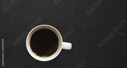 Top up view isolated hot black coffee isolated on dark table. added copy space for text.