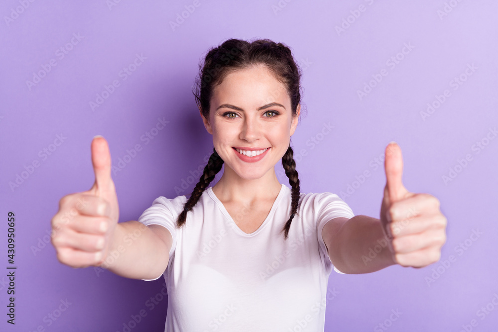 Photo of charming positive person show two hands thumbs up beaming smile isolated on violet color background Photo of charming positive person show two hands thumbs up beaming smile isolated on violet color background