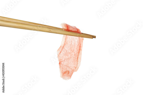 Chopsticks with pickled ginger isolated on white background