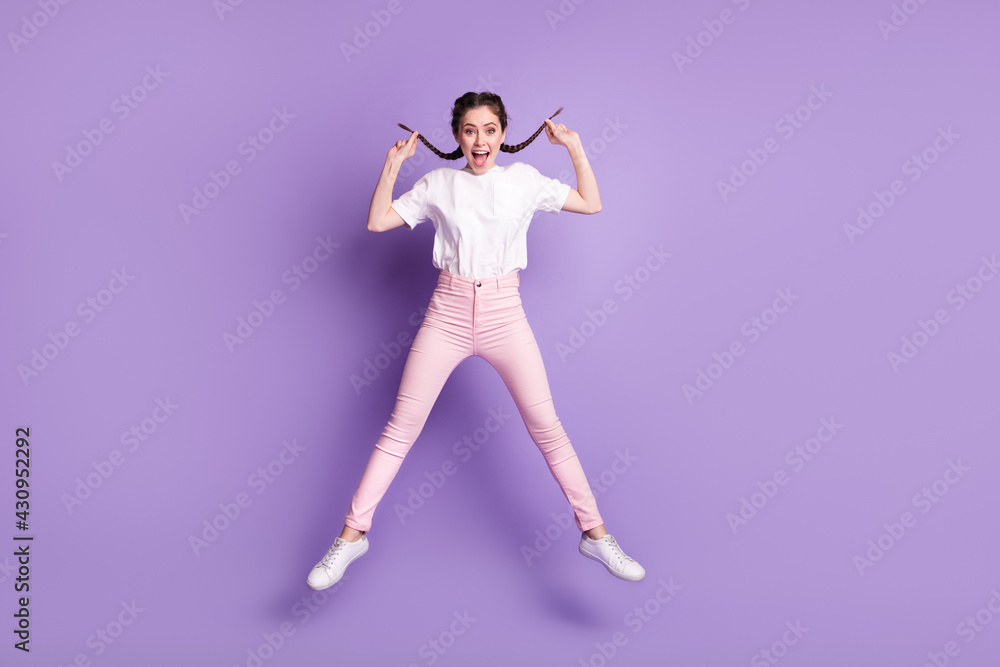 Fototapeta premium Full length photo of young attractive girl happy positive smile jump up isolated over violet color background