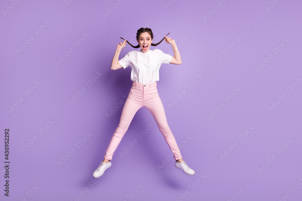 Full length photo of young attractive girl happy positive smile jump up isolated over violet color background