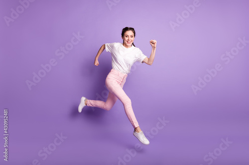 Fototapeta Naklejka Na Ścianę i Meble -  Full size photo of attractive cheerful nice young woman go run sale good mood isolated on purple color background