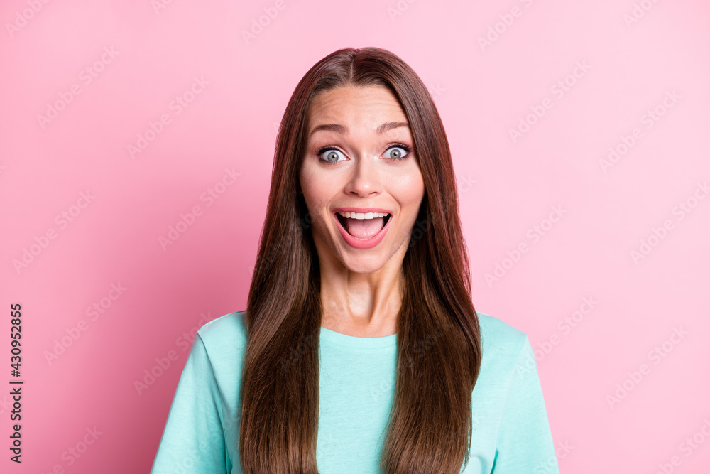 Portrait of young attractive happy shocked amazed surprised woman with open mouth sees sale isolated on pink color background Portrait of young attractive happy shocked amazed surprised woman with open mouth sees sale isolated on pink color background