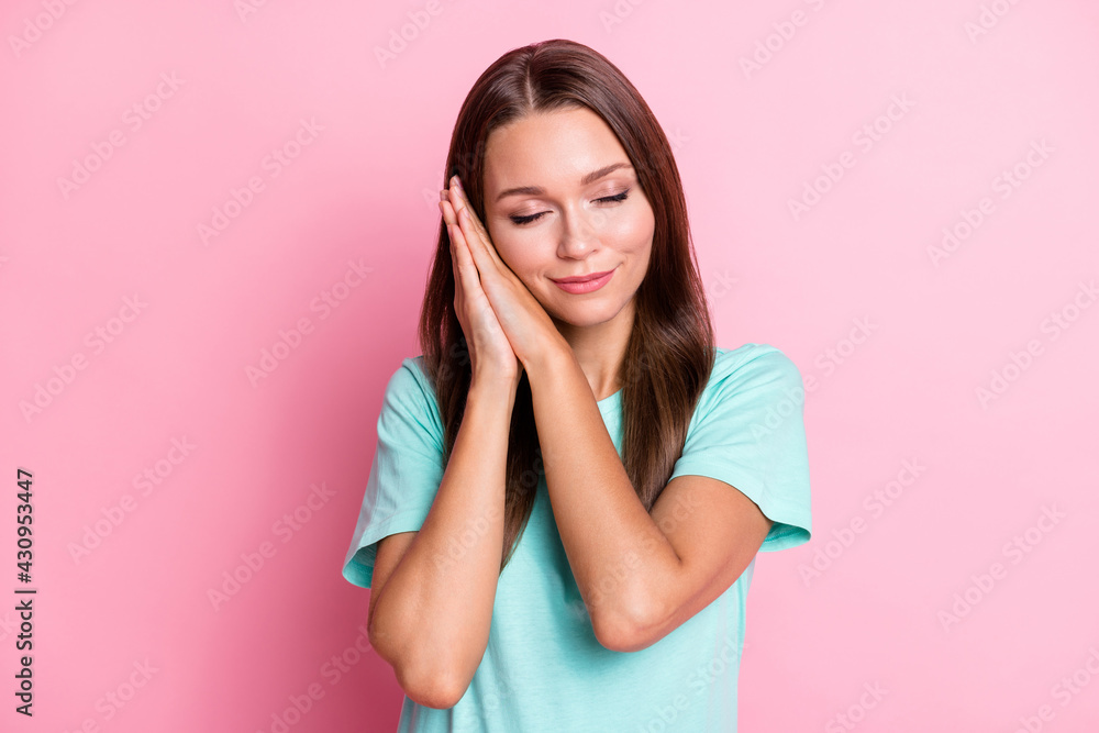 Photo portrait of relaxing sleeping pretty girl keeping hands together snoozing isolated on pastel pink color background Photo portrait of relaxing sleeping pretty girl keeping hands together snoozing isolated on pastel pink color background