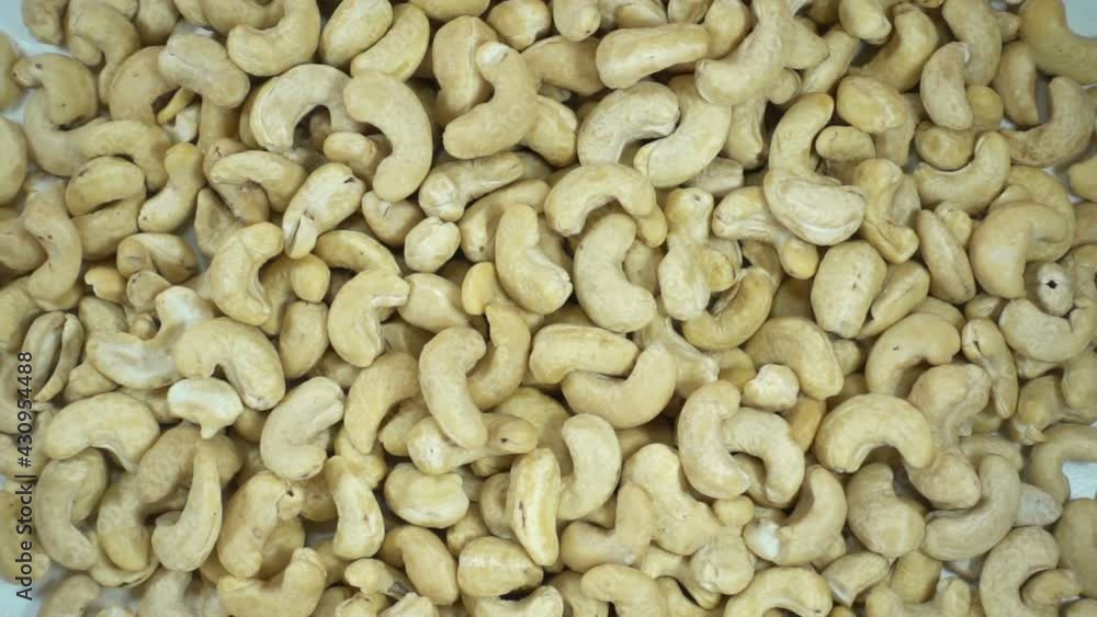 Cashew nuts falling in slow motion on a pile of nuts Cashew nuts falling in slow motion on a pile of nuts