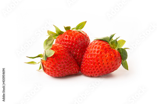 Wallpaper Mural Three strawberries with strawberry leaf on white background. Torontodigital.ca